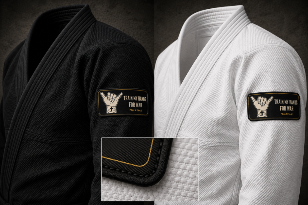 Product mockup: vertical woven TMHFW gi sleeve patch, roughly 4 inches tall — black-and-gold shaka crest strip with a merrowed edge, sized for the upper sleeve or pant thigh