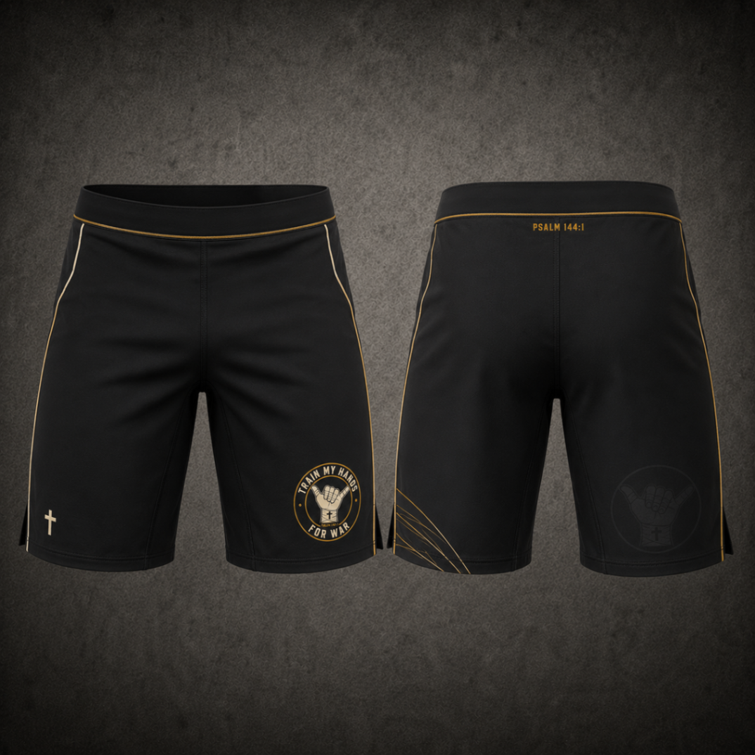Product mockup: front and back of matte obsidian TMHFW grappling shorts — antique-gold piping stripe down each outer leg, flat waistband with internal drawcord, and a small bone-and-gold shaka crest screen printed low on the left leg